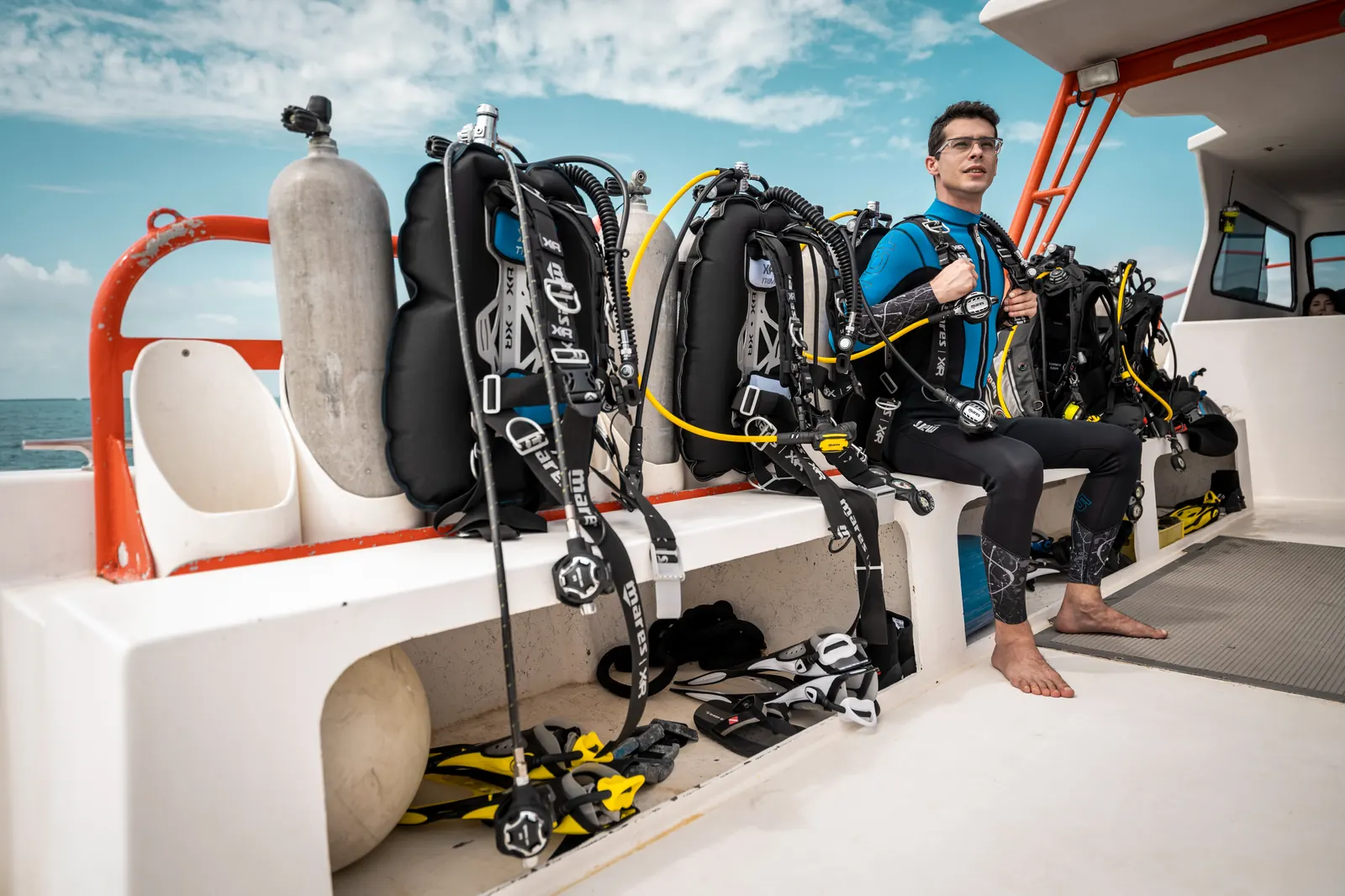 Diver gearing up with scuba equipment aboard the dive boat, Seahawks SCUBA