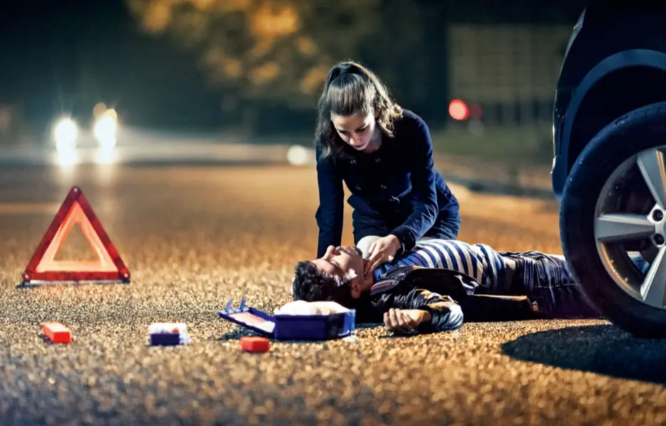 First responder giving roadside CPR and first aid