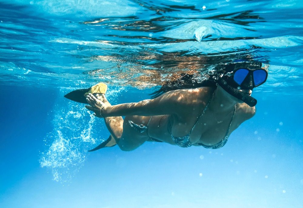 Snorkeller exploring shallow reef, Havelock Island