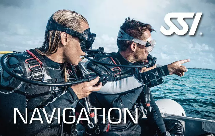 2 scuba divers with full scuba gear standing on a dive boat in the middle of sea text says "SSI navigation" course