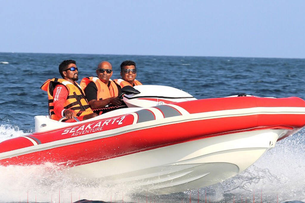 3 people riding a sea kart over deep blue waters of Andaman sea