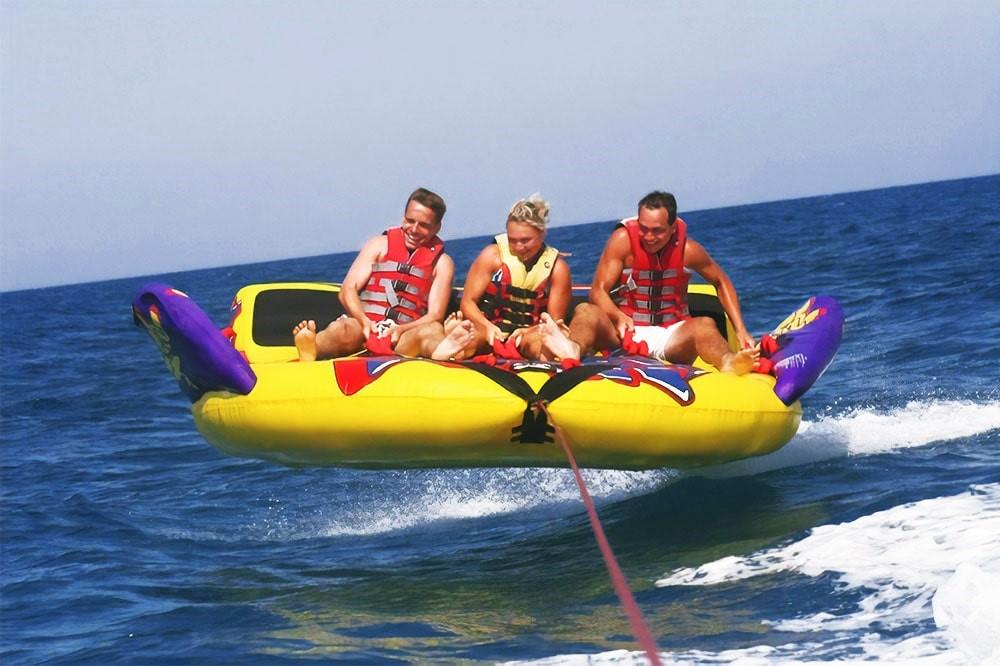 3 people enjoying a sofa ride over the deep blue waters of Andaman